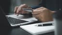 Person entering payment details at a keyboard